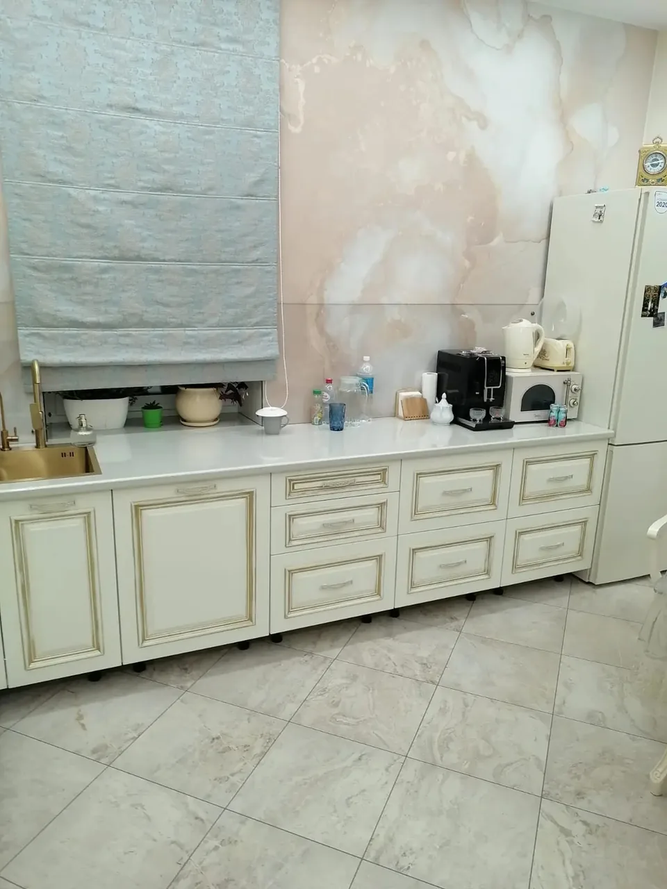 Длинный ряд нижних шкафов кухни с патинированными фасадами